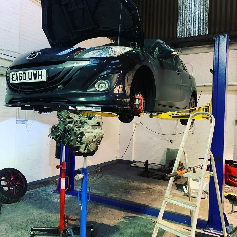 Car on a ramp for servicing at CJ Performance garage in Mansfield